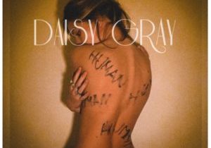 Official cover of the single Human by Daisy Gray showing her with a naked back and the word human written all over